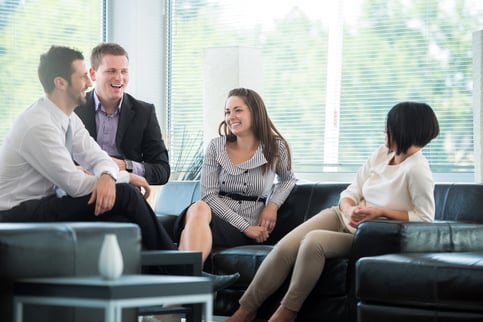 Four business people talking on a break in modern environment